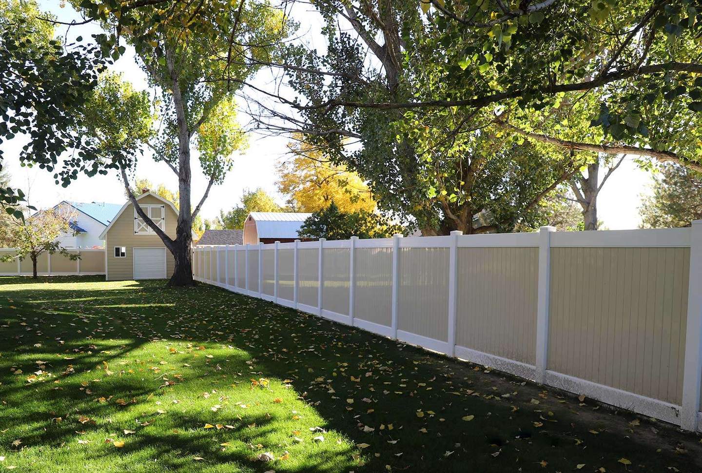 Clean residential fence line beside a landscaped yard